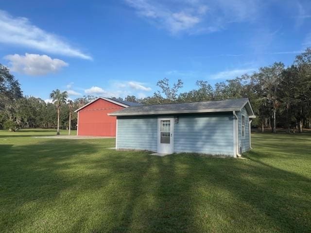 view of outbuilding featuring a yard