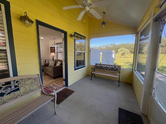 sunroom / solarium with vaulted ceiling and ceiling fan