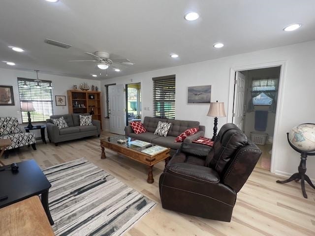 living room featuring ceiling fan and light hardwood / wood-style flooring