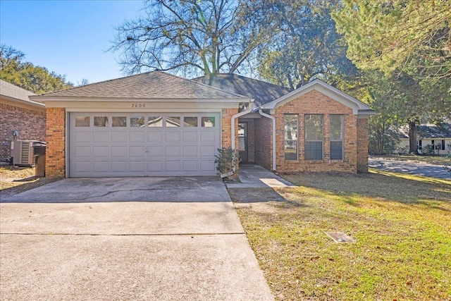 ranch-style house featuring a garage, central air condition unit, and a front yard