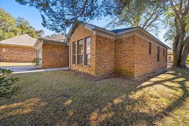 view of home's exterior featuring a garage and a lawn