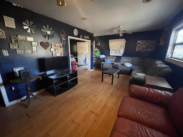 living room with wood-type flooring and ceiling fan