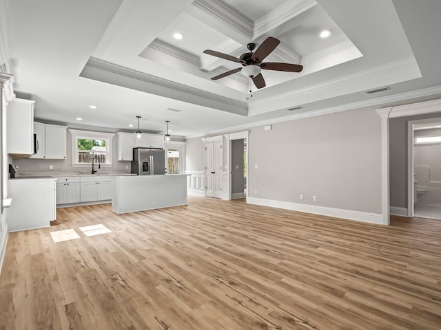 unfurnished living room featuring crown molding, coffered ceiling, ceiling fan, and light hardwood / wood-style flooring