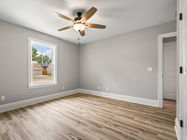 spare room featuring ceiling fan and light wood-type flooring