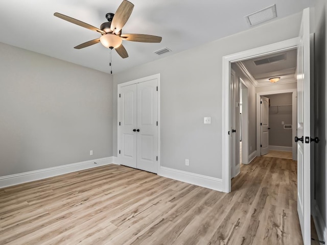 unfurnished bedroom featuring a closet, ceiling fan, and light hardwood / wood-style flooring