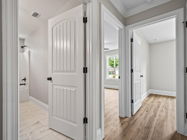 hall featuring ornamental molding