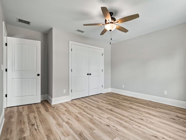 unfurnished bedroom with light hardwood / wood-style floors, a closet, and ceiling fan