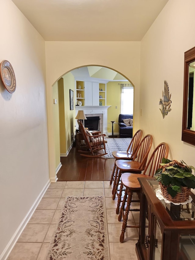 2736 Oakleigh Ct, Tallahassee, FL 32312 - hallway with arched walkways, baseboards, and tile patterned flooring