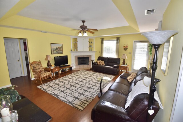 2736 Oakleigh Ct, Tallahassee, FL 32312 - living area featuring a ceiling fan, wood finished floors, a tiled fireplace, and built in features