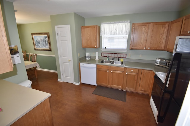 2736 Oakleigh Ct, Tallahassee, FL 32312 - kitchen featuring dishwasher, a sink, light countertops, and dark wood-style flooring