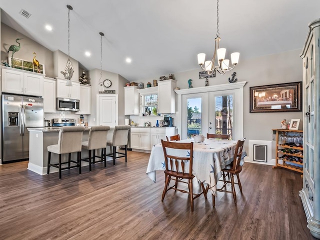 dining space with high vaulted ceiling, dark hardwood / wood-style floors, french doors, and an inviting chandelier