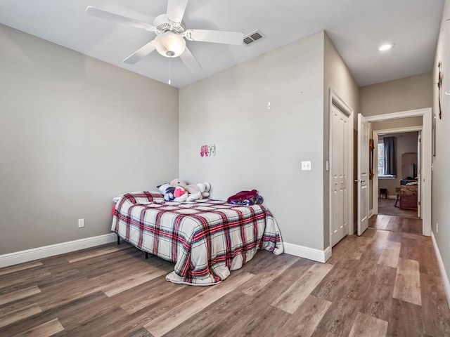 bedroom with hardwood / wood-style floors and ceiling fan