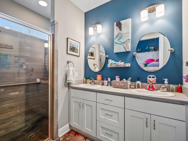 bathroom featuring vanity and a shower with shower door