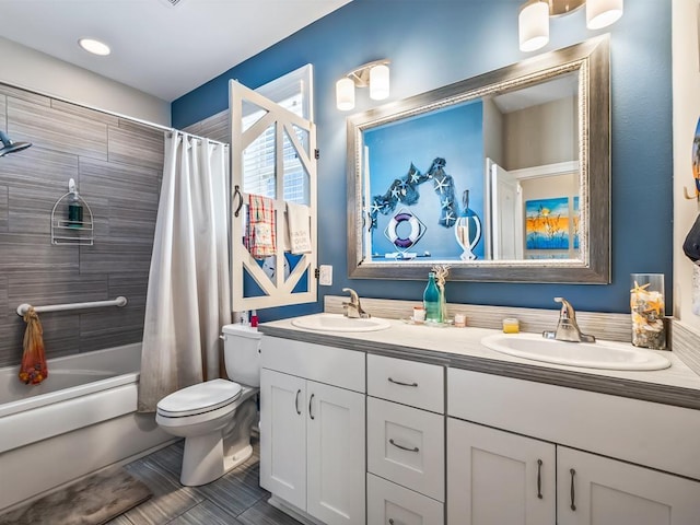 full bathroom featuring toilet, shower / tub combo with curtain, and vanity