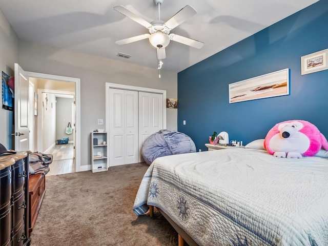 carpeted bedroom with a closet and ceiling fan