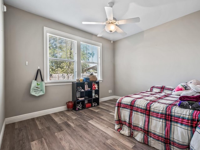 bedroom with ceiling fan and wood-type flooring