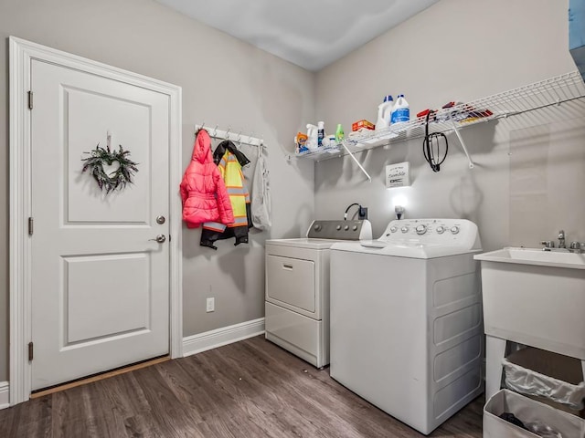 laundry area featuring dark hardwood / wood-style flooring, separate washer and dryer, and sink