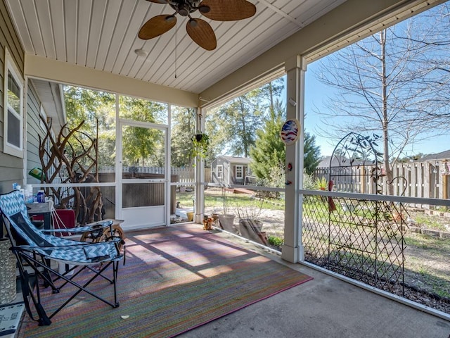 sunroom / solarium featuring ceiling fan