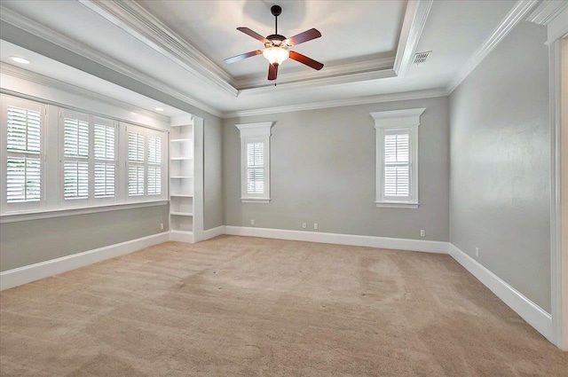 spare room with light colored carpet, crown molding, plenty of natural light, and ceiling fan