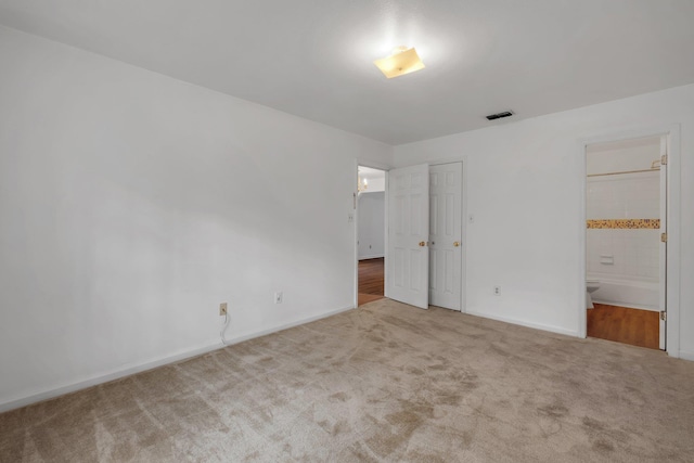 4027 Catawba St Unit B, Tallahassee, FL 32303 - unfurnished bedroom with carpet flooring, baseboards, and ensuite bathroom