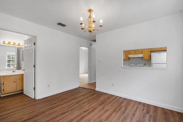 4027 Catawba St Unit B, Tallahassee, FL 32303 - empty room featuring a chandelier, dark wood-style floors, baseboards, and a sink