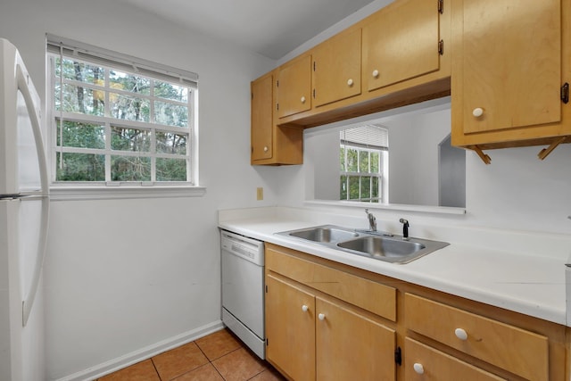 4027 Catawba St Unit B, Tallahassee, FL 32303 - kitchen with white appliances, a sink, light countertops, light tile patterned floors, and baseboards