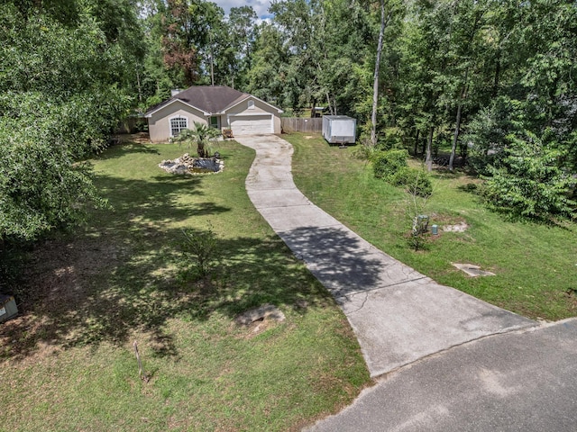 51 Mulberry Cir, Crawfordville, FL 32327 - view of green lawn with driveway and a storage shed