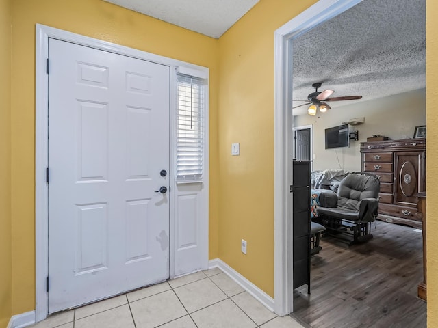 51 Mulberry Cir, Crawfordville, FL 32327 - foyer entrance with a ceiling fan, light tile patterned floors, and a textured ceiling