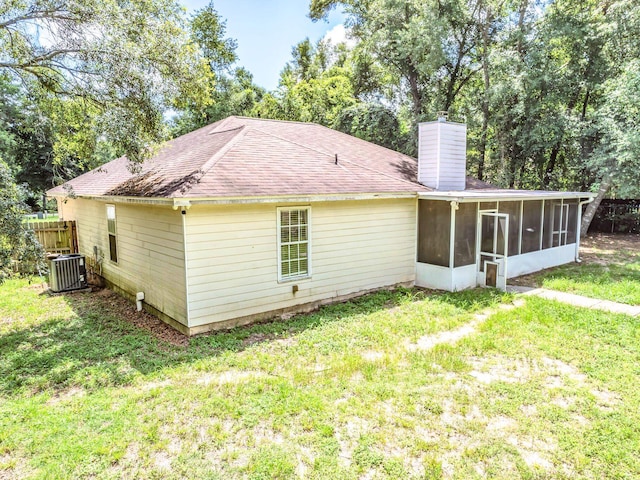 51 Mulberry Cir, Crawfordville, FL 32327 - rear view of house with a sunroom, a chimney, and a shingled roof