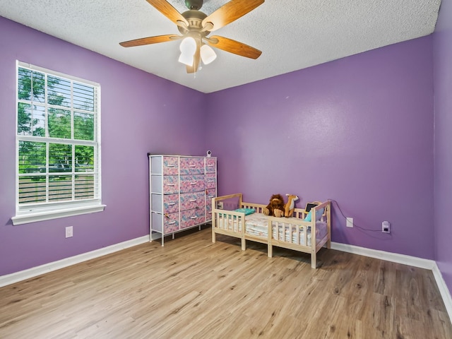 51 Mulberry Cir, Crawfordville, FL 32327 - bedroom featuring wood finished floors, a textured ceiling, and ceiling fan