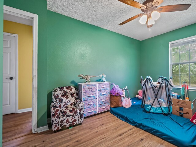 51 Mulberry Cir, Crawfordville, FL 32327 - bedroom with a textured ceiling, wood finished floors, and ceiling fan
