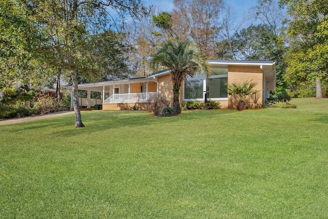 single story home featuring a front lawn and covered porch