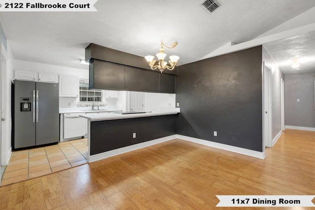 kitchen featuring white dishwasher, visible vents, white cabinetry, light countertops, and stainless steel fridge with ice dispenser