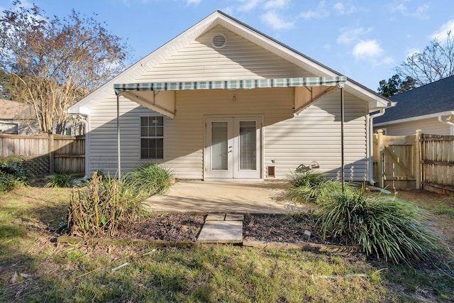 rear view of property with french doors, a patio area, and fence