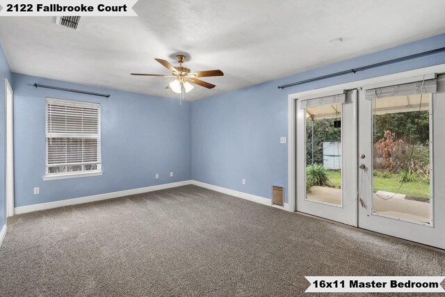 unfurnished room featuring light colored carpet, ceiling fan, visible vents, and baseboards