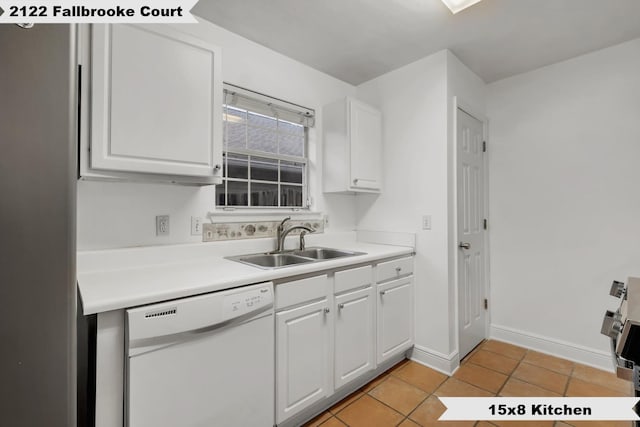 kitchen with light countertops, white dishwasher, a sink, and wallpapered walls