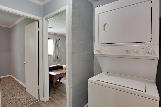 316-328 E Pershing St Unit 316-328, Tallahassee, FL 32301 - laundry room with crown molding, light hardwood / wood-style flooring, and stacked washing maching and dryer