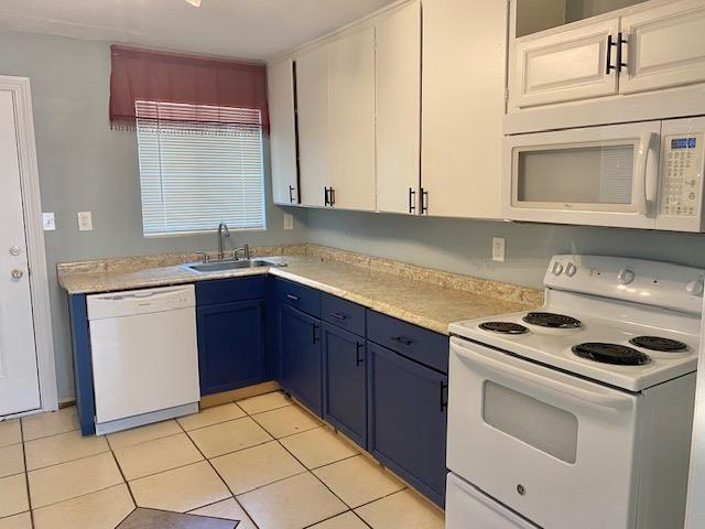 316-328 E Pershing St Unit 316-328, Tallahassee, FL 32301 - kitchen with blue cabinetry, sink, white cabinetry, light tile patterned floors, and white appliances