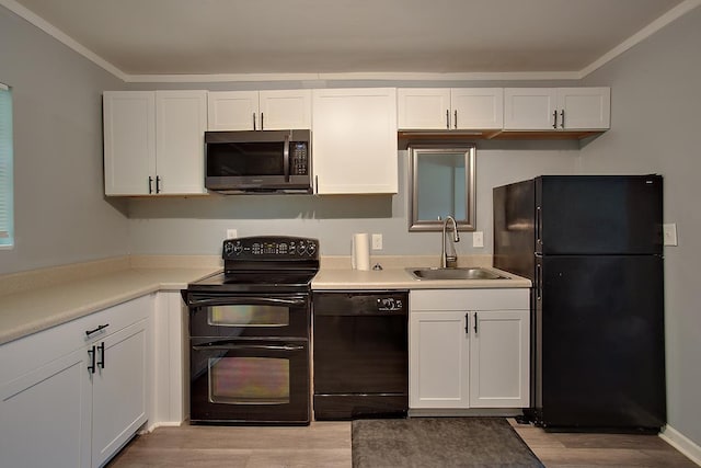 316-328 E Pershing St Unit 316-328, Tallahassee, FL 32301 - kitchen with sink, white cabinetry, ornamental molding, light hardwood / wood-style floors, and black appliances
