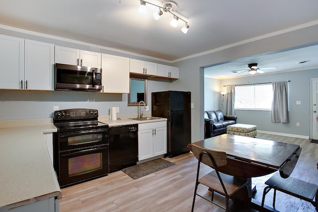 316-328 E Pershing St Unit 316-328, Tallahassee, FL 32301 - kitchen featuring sink, crown molding, black appliances, light hardwood / wood-style floors, and white cabinets