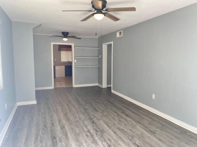 interior space featuring dark wood-type flooring and ceiling fan