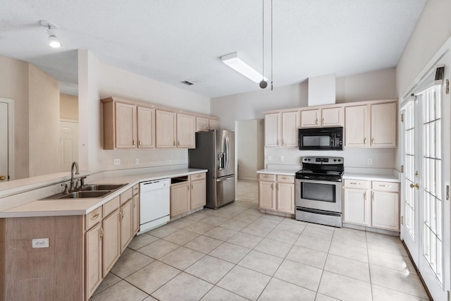 8827 Sapphire Dr, Tallahassee, FL 32309 - kitchen featuring stainless steel appliances, a sink, light brown cabinetry, a peninsula, and light countertops