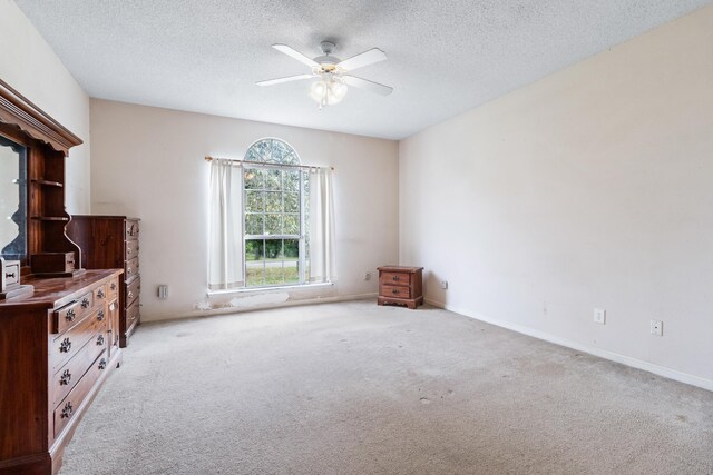 8827 Sapphire Dr, Tallahassee, FL 32309 - unfurnished bedroom featuring carpet floors, a textured ceiling, ceiling fan, and baseboards