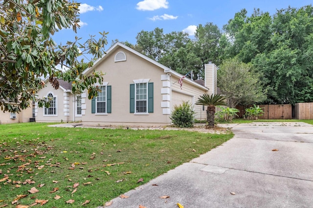 8827 Sapphire Dr, Tallahassee, FL 32309 - view of front of property featuring driveway, an attached garage, a chimney, and stucco siding