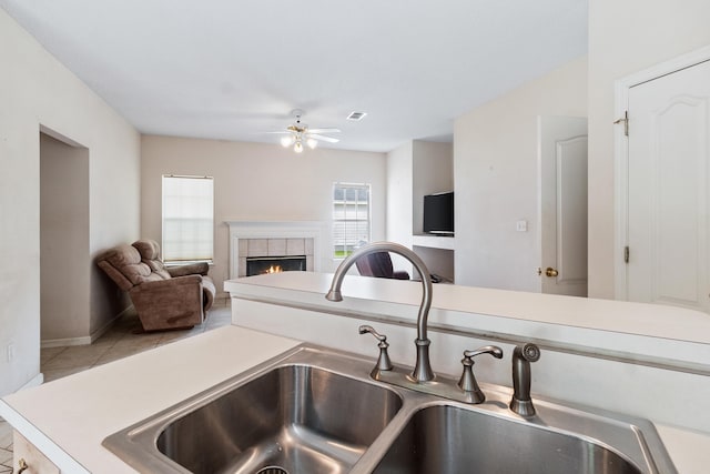 8827 Sapphire Dr, Tallahassee, FL 32309 - detailed view of a sink, a ceiling fan, a fireplace, and baseboards