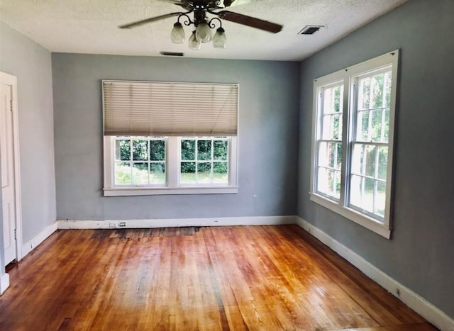 spare room with wood-type flooring, a textured ceiling, and ceiling fan