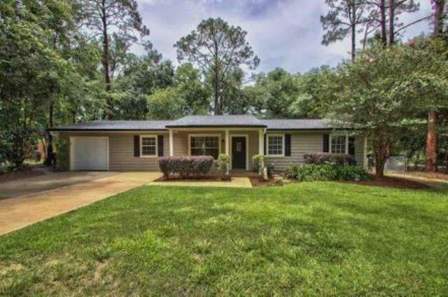 single story home featuring an attached garage, driveway, and a front lawn