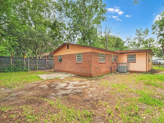 back of property featuring central air condition unit