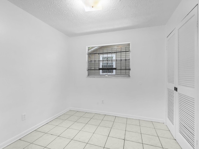 spare room with a textured ceiling