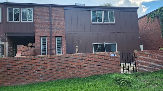 220 Belmont Rd Unit 3, Tallahassee, FL 32301 - view of side of home featuring board and batten siding, a gate, and brick siding